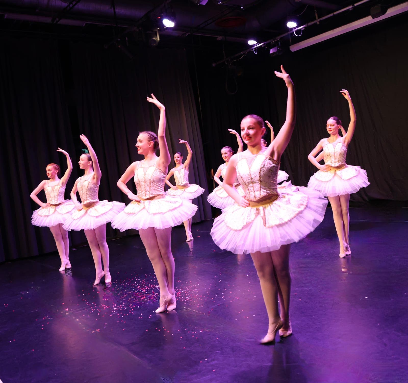 Ballet company in white and gold tutus