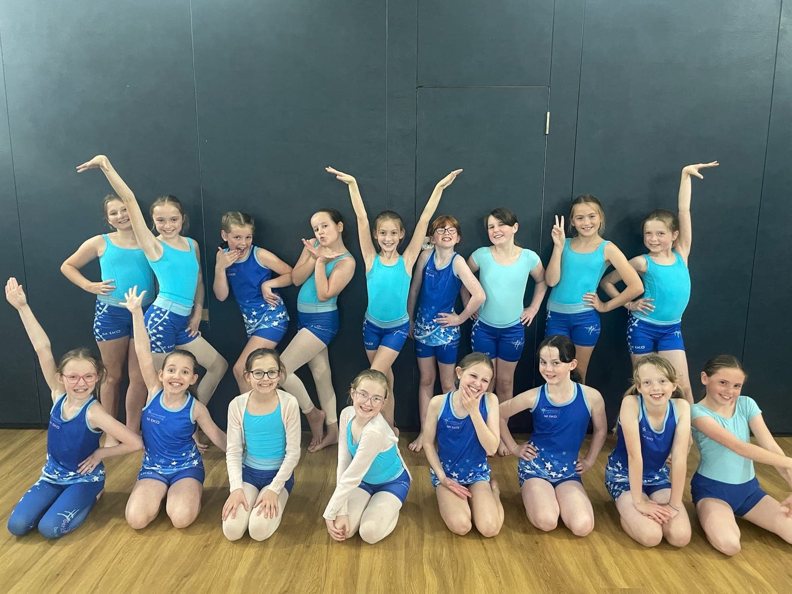 Junior dancers in turquoise and royal blue studio kit
