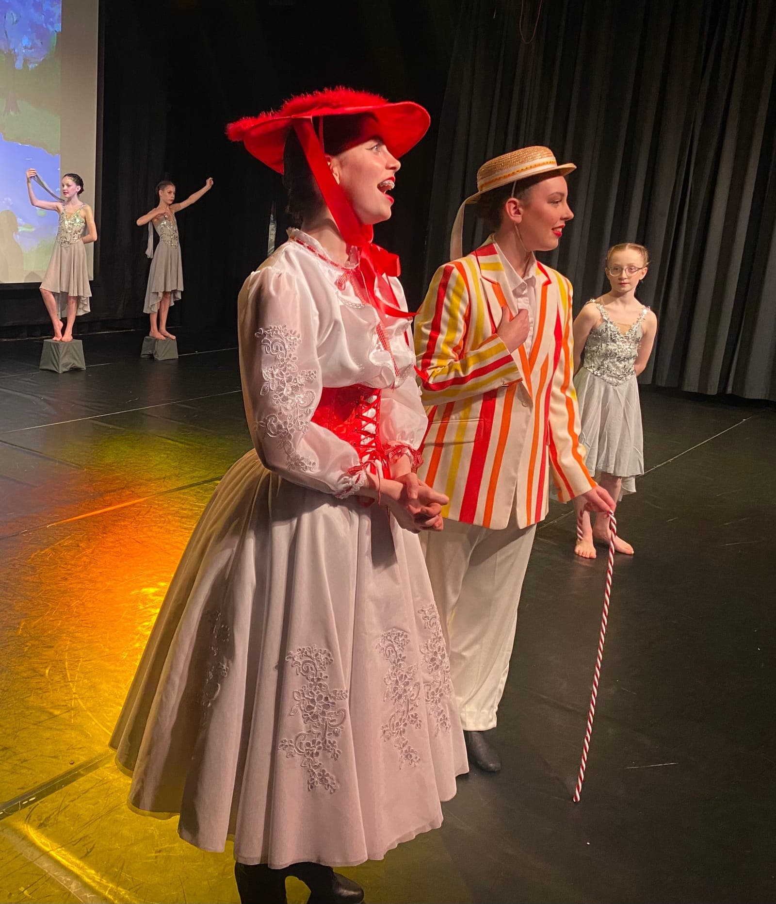 Musical theatre dancers in Mary Poppins costumes