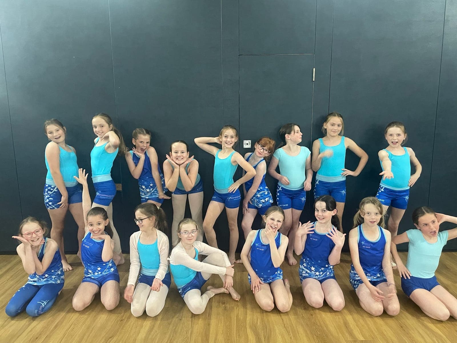 A group of students in turquoise and blue kit in the studio