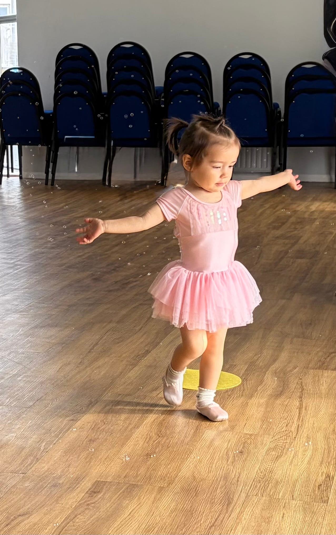 A toddler in a pink tutu dancing in class at the Geraldine Lamb Dance School